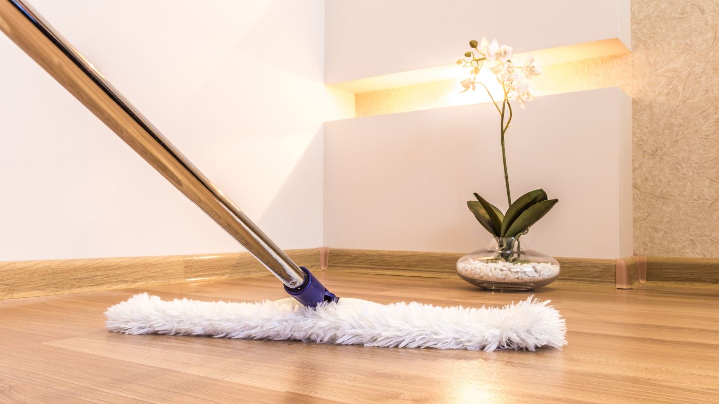 Professional deep cleaning with microfiber mop on hardwood floors